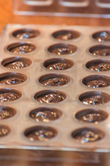 Part of the process of making homemade artisan chocolate sweets with different fillings for a special ocassion: valentine's day, a birthday or anniversary gift or the perfect souvenir
