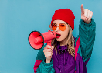 woman in red hat, sunglasses and suit of 90s with loudspeaker