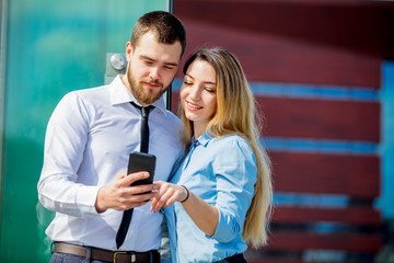 businesswoman and businessman with mobilephon planing a work