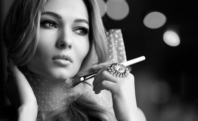 Obraz premium Beauty woman hold makeup professional tools mascara eyelashes brush for makeup have clear healthy face portrait 