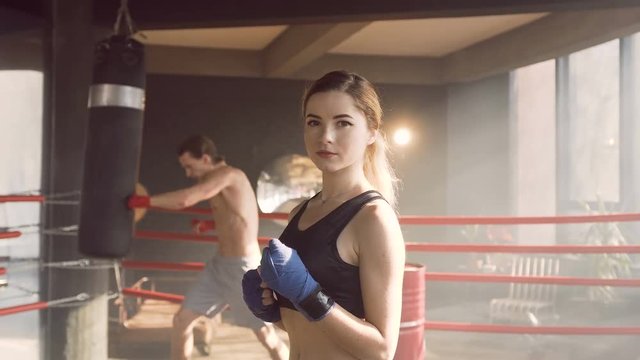 Portrait of female boxer in the boxing club.