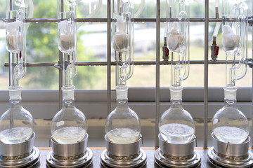 Soxhlet Extractor.Percolator-boiler and reflux,distillation flask on heating element.
