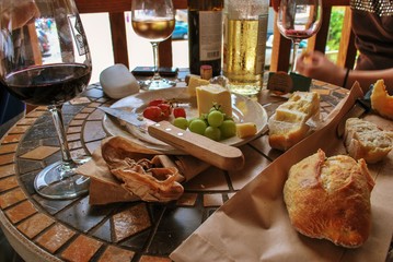 Wine tasting with food on round table on out door balcony 