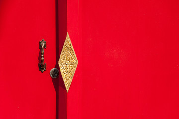 red door with carved door handle - 257559096