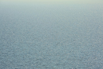 Fototapeta na wymiar blue distant sea texture with small waves