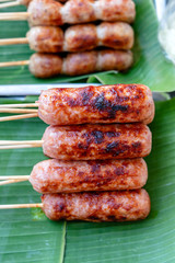 Grilled Thai sausage at street food market in Thailand. Traditional Thai sausage with pork and rice, delicious street food.