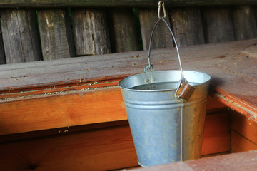 Galvanized bucket of a village well with a load and chain