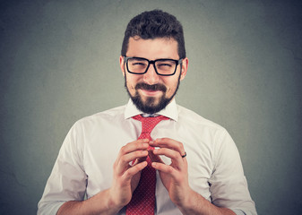 Sly businessman in glasses looking at camera plotting a revenge