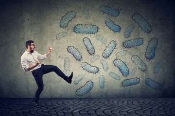 Angry confident man fighting bacteria - obrazy, fototapety, plakaty