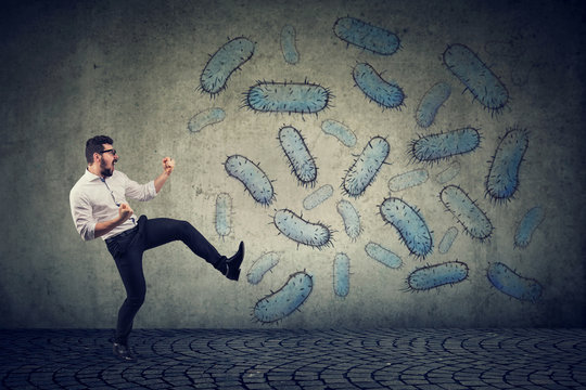 Angry confident man fighting bacteria