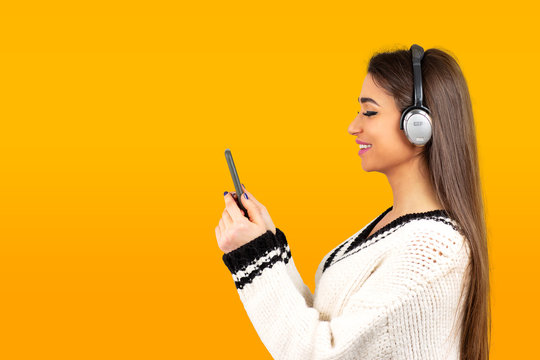 woman listening to music with headphones on cellphone