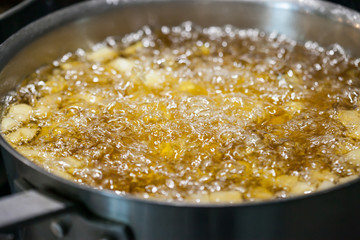 The water is boiling from cooking in the chef's kitchen.