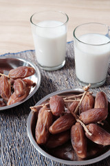 Bowl of dates fruits and glass of milk, usually consumed when break fasting