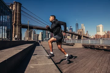 Athelte man running in New York City street wearing sport clothes © Nick Starichenko