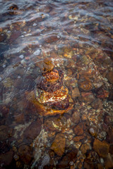 Stacked of rock in the waving sea, zen stone style