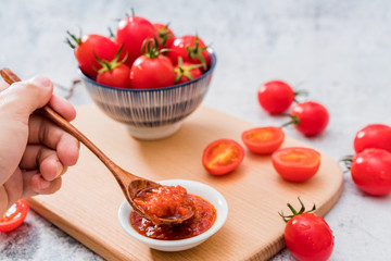 A plate of ketchup and tomatoes