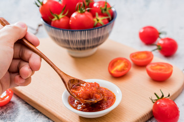 A plate of ketchup and tomatoes