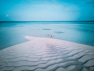 Aerial drone photo - A woman in the Maldives islands.