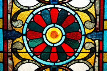 Closeup of very old, colorful stained glass.
