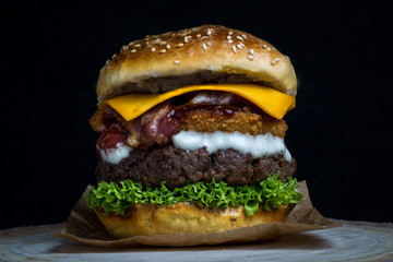 Cheeseburger with bacon, onion rings, lettuce, barbecue and mayonnaise