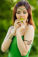 Beautiful young asian woman eating fresh kiwi