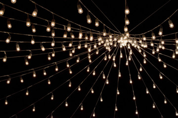 Lightbulbs hanging on cable as garland pattern, lightbulb decorative in festival, lightbulb string...