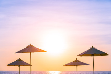 Umbrella and chair around swimming pool in resort hotel for leisure travel and vacation