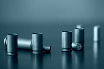 Empty old bullet cartridges close up. Blue color toned