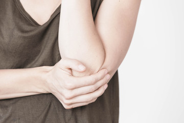 Woman grabbing elbow in pain