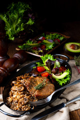 Pork steak with mushrooms and buckwheat groats and mango salad