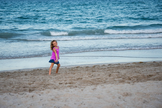 Young girl dancing on the beach