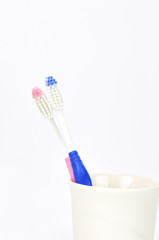 tooth brushes in glass