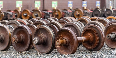 Train wheels in a train yard in an organized row for storage