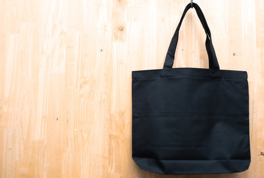 Black Plain Mock Up Tote Shopping Bag On Wooden Background.