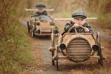 Competition between the two boys on improvised racing cars