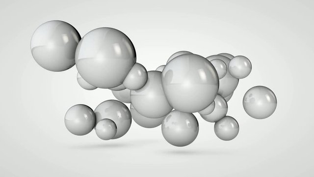3D animation of a white ball that splits into many small spheres in space.