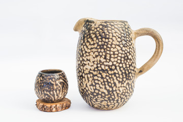 pitcher and ceramic stoneware tumbler with white background