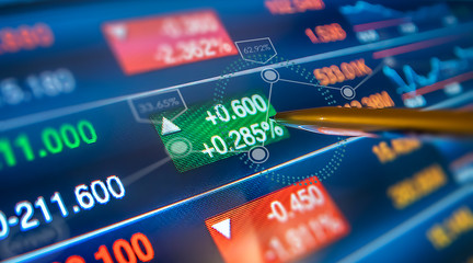 Financial data screen, pen showing rising data.