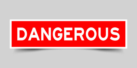 Label sticker in red color square shape as word dangerous on white background