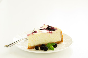 Homemade cheesecake with black currant jelly.