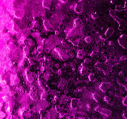Ice on pink glass as abstract background
