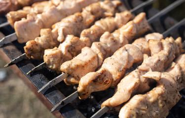 Shish kebab on skewers is fried on a brazier