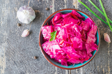 Marinated white cabbage with beet and spices with pickled parsley leaves