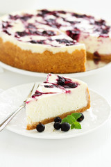 Homemade cheesecake with black currant jelly.