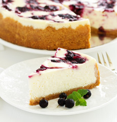 Homemade cheesecake with black currant jelly.