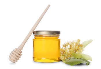 Jar of linden honey, honey dipper and lime flowers isolated on white background.
