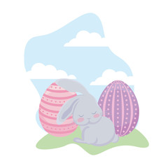 cute rabbit with eggs of easter in grass