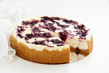 Homemade cheesecake with black currant jelly.