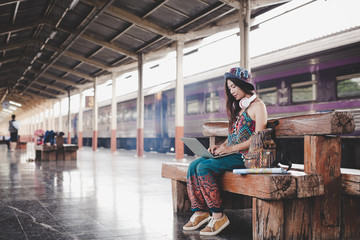 Obraz na płótnie Canvas Women holding a map at the train station Tourism concept