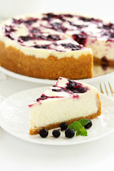 Homemade cheesecake with black currant jelly.